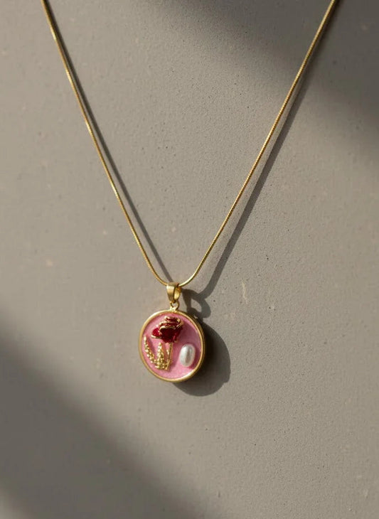 Necklace with a round pendant featuring a floral design on a gray background