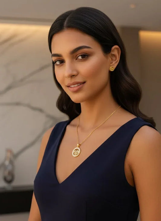 Woman wearing a navy blue dress with gold jewelry indoors