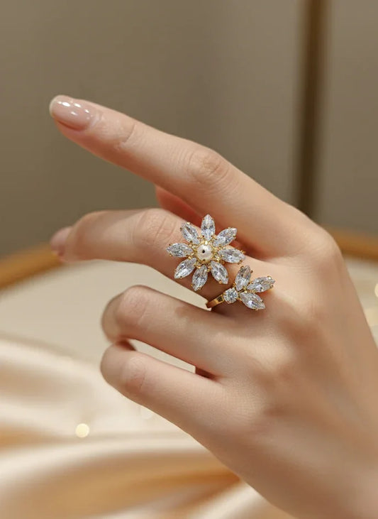 Hand wearing a decorative ring with a blurred background